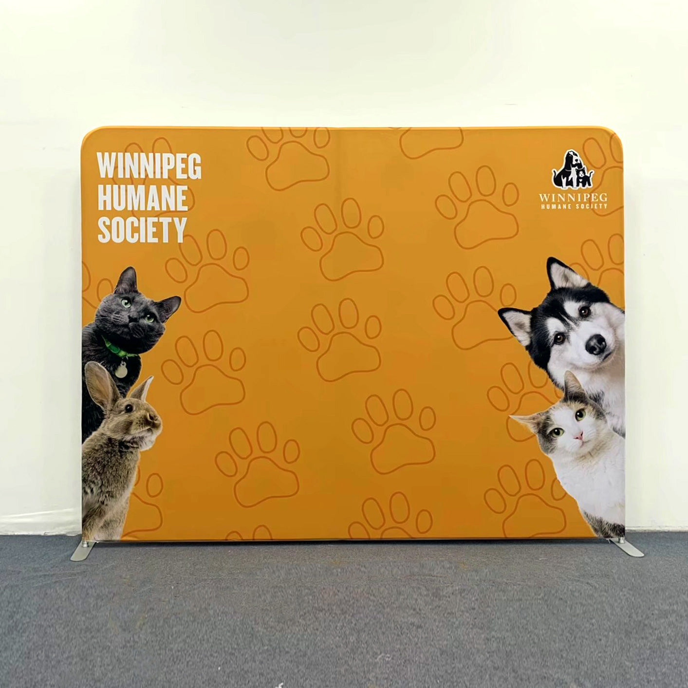 Orange backdrop with paw prints and images of animals, featuring 'Winnipeg Humane Society'.
fabric backdrop media banner, fabric backdrop media banner Winnipeg, fabric backdrop media banner Manitoba, fabric backdrop media banner for event, fabric backdrop media banner for tradeshow, fabric backdrop media banner for reception, fabric backdrop media banner for event Winnipeg, media Wall Winnipeg